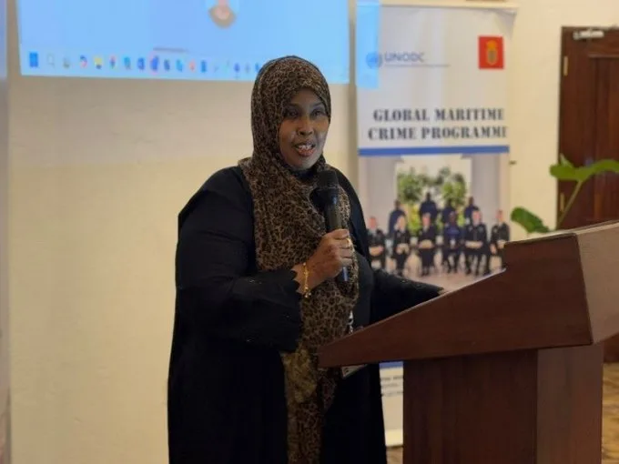 Sagal Abdirizak speaks into a microphone at a UNODC Global Maritime Crime Programme event